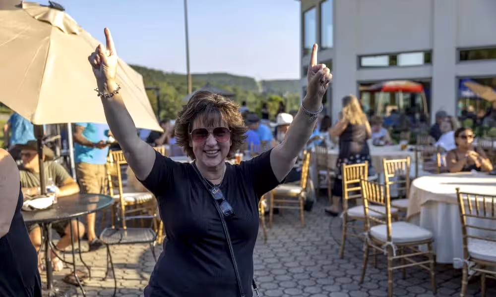 Woman throws her hands in the air.